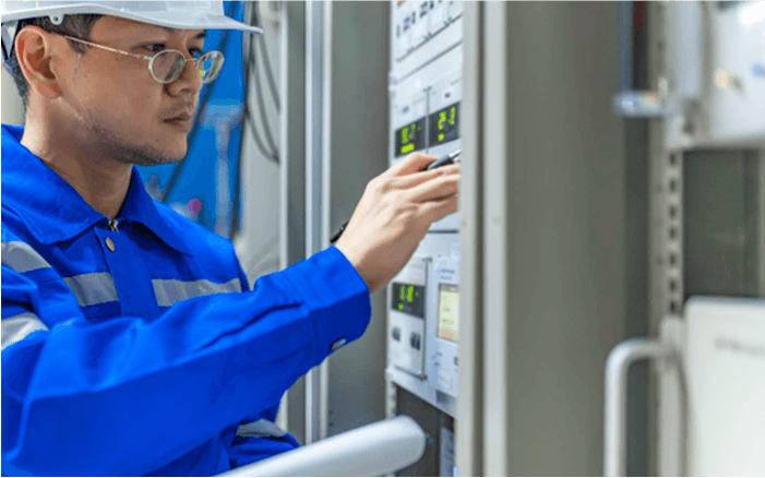 A picture of a worker operating embedded computers in a factory 